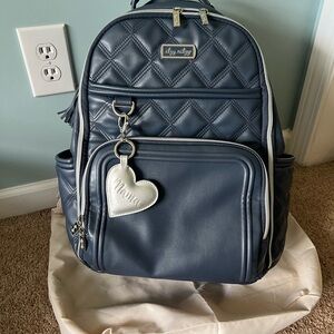 Itzy Ritzy Quilted Navy and White Trim Diaper Backpack with Silver Heart Charm